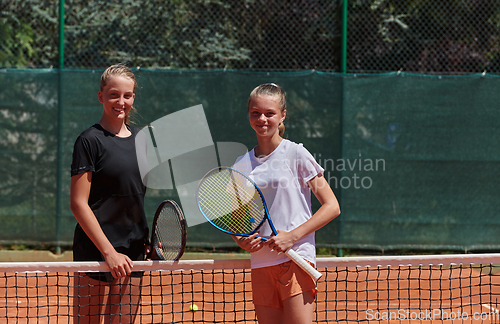 Image of Tennis players standing together on the tennis court, poised and focused, preparing for the start of their match