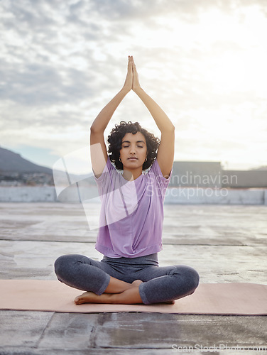 Image of Yoga meditation, peace and woman praying for spiritual wellness and gratitude in the morning in the city of Singapore. Girl training her mind to relax with faith, zen and exercise for stress