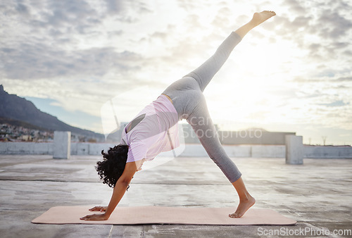 Image of Stretching, balance and woman yoga in the city and exercise for wellness, body health and fitness lifestyle. Meditation, workout and commitment with healthy pilates training outdoor in urban town