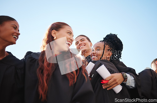 Image of Students, hug and graduation certificate success in ceremony celebration on school, university or college campus. Low angle, friends diversity or graduate diploma in education learning or scholarship