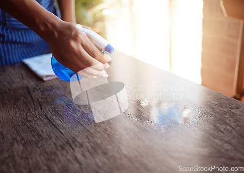 Image of Cleaner, hand and spray cleaning table with sanitizer in home, office or restaurant. Waitress, waiter and bottle with chemical to clean dirt, bacteria or covid 19 in cafe, house or coffee shop