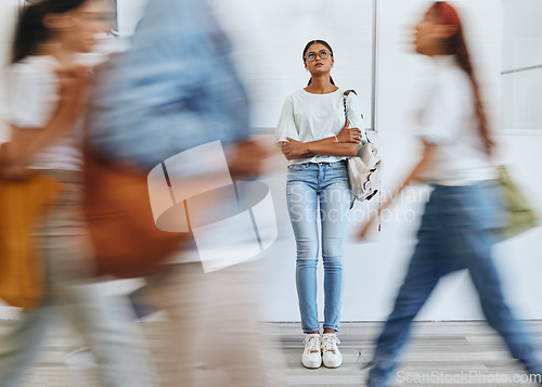 Image of Anxiety, fear and a woman in busy crowded university sad and thinking. Stress, doubt and depression, student in hallway before interview, exam or class. Motion blur, people and girl waiting in lobby.