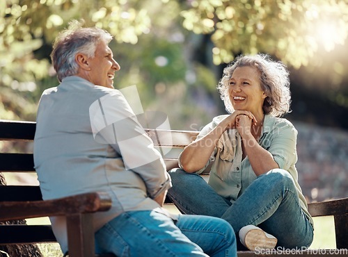 Image of Park bench, couple and senior people with love and happiness in nature enjoying summer. Happy smile of elderly woman and man retirement together relax laughing outdoor having a fun conversation