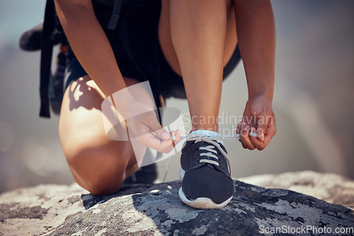 Image of Sports, hand and shoe of hiker in fitness motivation, woman ready for walk, run or climb in the outdoors. Hands of female tie shoes for hiking, adventure or trekking in nature exercise or sport