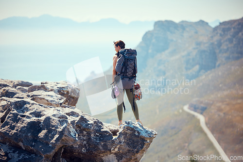 Image of Hiker, adventure and mountain top of a woman in rock climb, view and backpacking in nature. Active female traveler on trekking or hiking journey standing on cliff with beautiful view of the outdoors