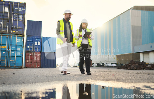 Image of Logistics, digital tablet and industrial employees working on an outdoor cargo freight delivery site. Supply chain, collaboration and black people planning stock, container and shipping information.