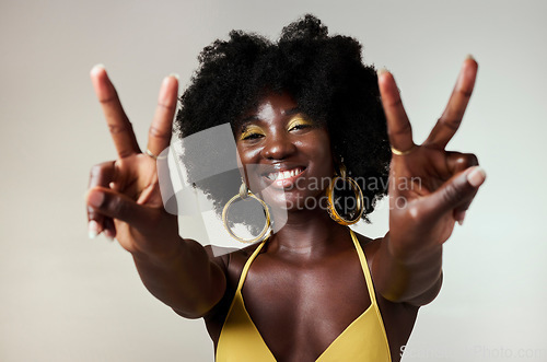 Image of Black woman, peace sign and fashion afro hairstyle on studio background with style, trend and makeup cosmetics. Portrait, fun or happy beauty model with playful and good energy hands gesture in Congo