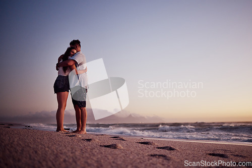Image of Love, beach and footprints in the sand with couple at sunset for support, hug or happy on Cancun summer vacation. Trust, goals and hope with man and woman by the sea on holiday for travel and romance