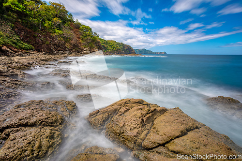 Image of Long exposure, pacific ocean waves on rock in Playa Ocotal, El Coco Costa Rica