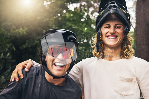 Image of Friends taking a selfie together after cycling through nature trail in the forest. Portrait of cyclist men from Sweden or Norway smiling wearing mountain biking helmets after bicycle ride in a park