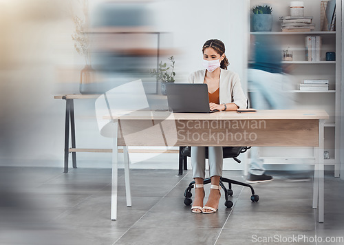 Image of Covid employee, office busy and woman on the internet with a laptop at a desk in an open creative workplace. Marketing employee with face mask at a fast startup company for safety from virus