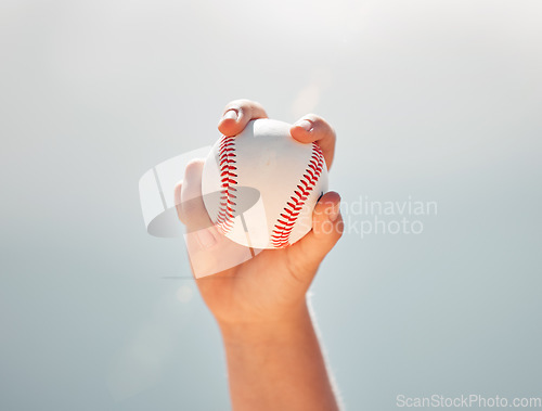 Image of Baseball, athlete hands and ball sports while showing grip of pitcher against a clear blue sky. Exercise, game and softball with a professional player ready to throw or pitch during a match outside