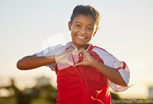 Image of Heart hand and girl portrait at soccer game with passionate and happy sports player in Mexico. Mexican child football athlete in match showing appreciation, happiness and joy with love shape.