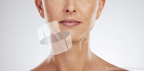 Image of Woman, lips and mature in zoom of mouth for cosmetics, beauty and health. Model, face and skin in dermatology portrait of wellness, facial and skincare in cosmetic closeup against studio background