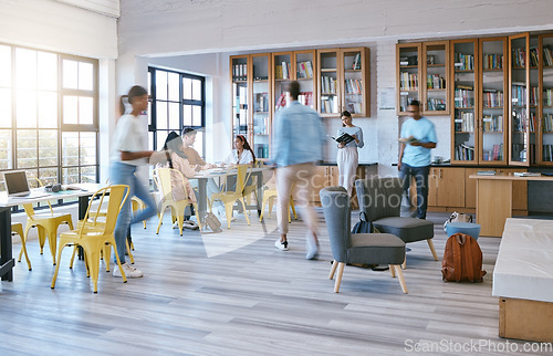 Image of Creative campus, busy library and students studying, research or working in community workspace with morning lens flare. People with education school books, reading information in college motion blur