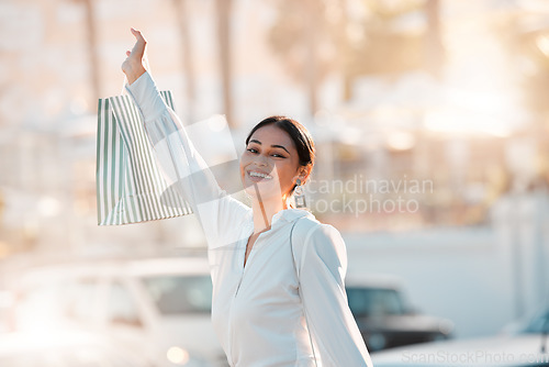 Image of Shopping bag, customer and retail woman in city bokeh street for fashion, clothes or gift. Celebration of discount, sale and person clothes luxury, wealth or urban lifestyle portrait walking outdoor