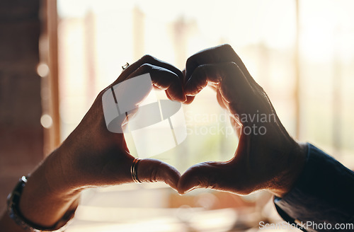 Image of Heart, hands and gesture for love, care and relationship in trust, unity and commitment. Closeup hand of couple together in romance shape for bonding sign or symbol against blurred background