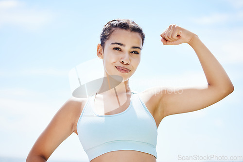 Image of Strong woman flexing arms, body and muscle power, fitness and wellness training on blue sky Colombia outdoors. Portrait proud female athlete, motivation and healthy goals of winner sports achievement