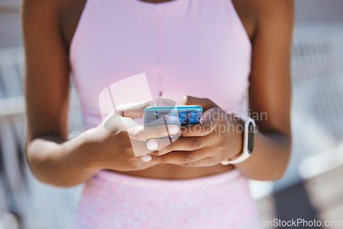 Image of Hands, phone and black woman texting during workout outdoor, social media and internet browsing. Fitness, yoga and black girl reading online posts, checking message and taking a break from meditation