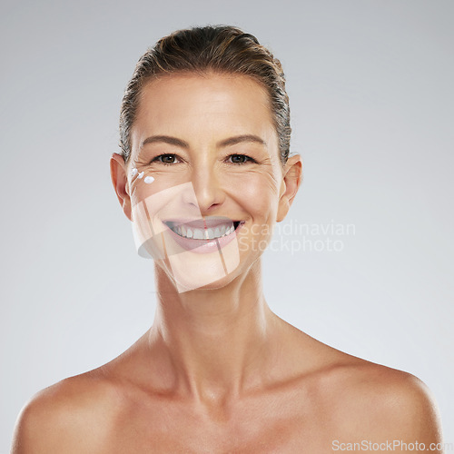 Image of Skin, skincare and beauty portrait of mature woman with anti aging cream on her face. Mockup for dermatology, wrinkles and facial care for youth. Happy smiling middle aged girl with natural beauty