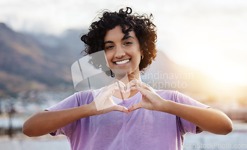 Image of Hand, heart and woman showing love sign in a city, travel, freedom and happy student. Portrait, smile and finger gesture with cheerful indian tourist enjoying foreign exchange programme in Mexico