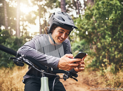 Image of Cycling man in forest, phone gps and map direction with adventure, nature trail and bicycle break in woods. Happy mountain bike sports athlete, mobile app search and typing location guide connection