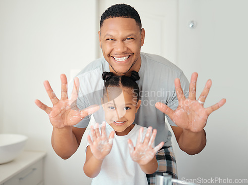 Image of Black family with soap on hands in bathroom for bacteria cleaning safety, learning or teaching hygiene healthcare portrait. Wellness father showing girl child how to wash germs with foam for skincare