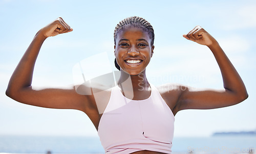 Image of Strong black woman flexing arms, muscle and body power, fitness and wellness in urban Jamaica outdoors. Portrait proud female athlete energy, exercise and happiness of healthy bodybuilder lifestyle