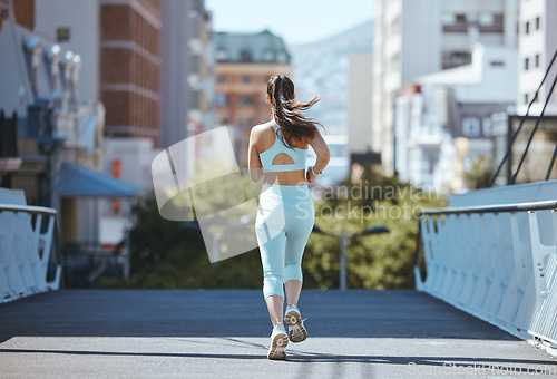 Image of Fitness, runner and back view of woman running, exercise and cardio training outdoors on bridge asphalt in summer. Wellness, sports and young girl on a healthy and active city jog workout on the road