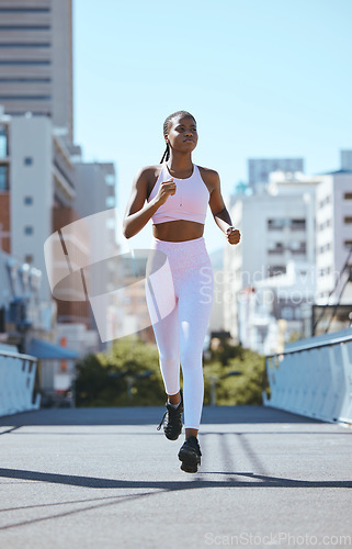 Image of Black woman, city running and cardio fitness training, workout and exercise in urban city outdoors. Focus, motivation and wellness of strong, healthy and african sports runner athlete sprint in town