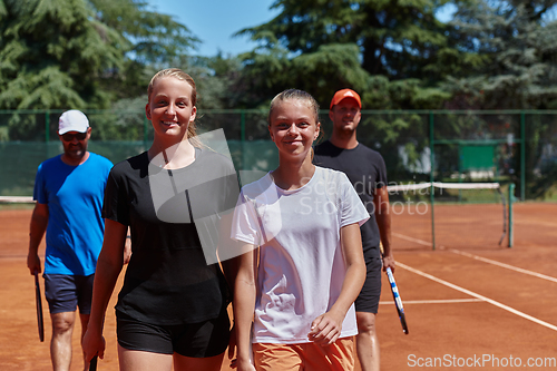 Image of Tennis club together after hard training, showing their dedication, hard work, and teamwork.