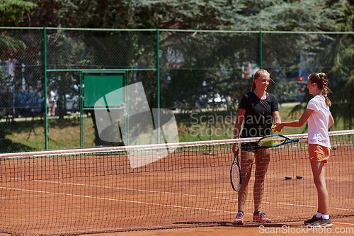 Image of Tennis players standing together on the tennis court, poised and focused, preparing for the start of their match