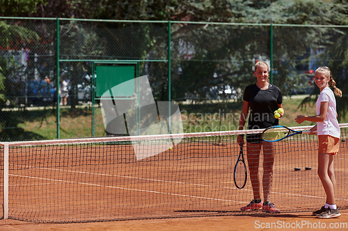 Image of Tennis players standing together on the tennis court, poised and focused, preparing for the start of their match