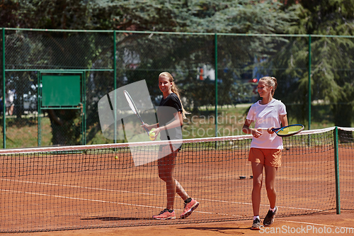 Image of Tennis players standing together on the tennis court, poised and focused, preparing for the start of their match