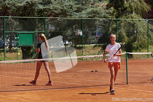Image of Tennis players standing together on the tennis court, poised and focused, preparing for the start of their match