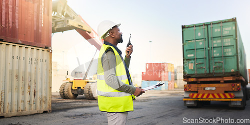 Image of Black man working on stock, logistics and cargo delivery in the transport and supply chain industry at the shipping port. Employee with radio communication to export container for export distribution