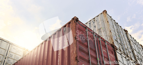 Image of Cargo container, logistics and shipping of import and export goods at storage in shipyard for global supply chain. Distribution, supply chain and industrial port against sky at international harbor