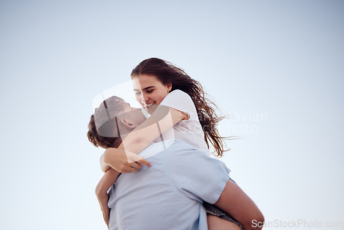 Image of Hug, happiness and love of a couple together in an embrace with a smile in summer. Happy girlfriend and boyfriend feeling relationship gratitude spending quality time with a blue sky background