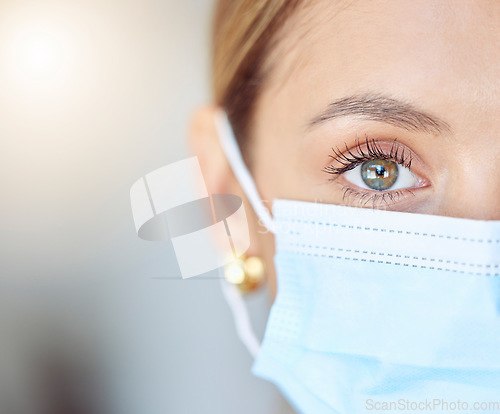 Image of Covid health, face mask and humanity with closeup of eye of young woman wearing protection, precaution and safety. Portrait of a female and healthcare against coronavirus, flu and cold in a pandemic