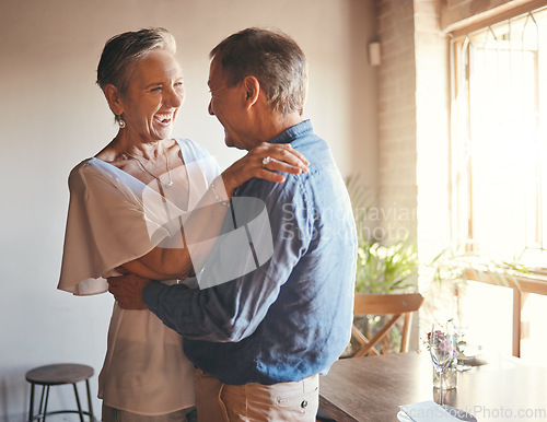 Image of Dance, freedom and retirement with senior couple dancing in celebration, having fun and bonding in living room. Fun, romance and active seniors sharing a funny joke and enjoying retired lifestyle