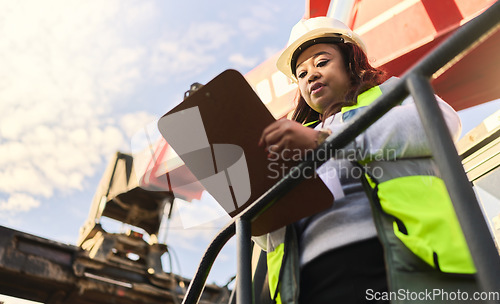 Image of Documents, shipping and supply chain with a logistics black woman working in export and import industry from below. Distribution, freight and cargo with a female courier reading an order form outside