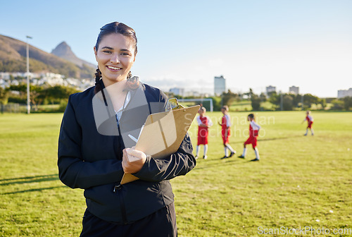 Image of Football coach, junior sports and woman with clipboard coaching children on a soccer field or pitch outside on a sunny day. Happy female pe trainer outside for practice, training and exercise class