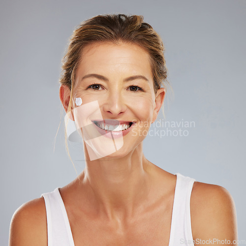 Image of Beauty, skincare and face with a mature woman in studio on a gray background for wellness and healthcare. Cosmetics, skin and body care with a happy female posing for antiaging, treatment or vitality