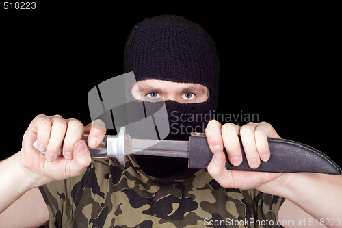 Image of Portrait of  the man with a knife over black