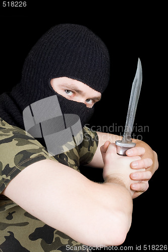 Image of The criminal with a knife in a black mask