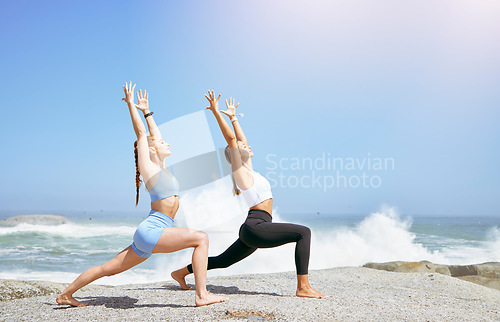 Image of Yoga fitness friends on beach, wellness at sunrise in zen Los Angeles and white women stretching body exercise. Spiritual meditation in summer, training motivation and relax breathe fresh ocean air