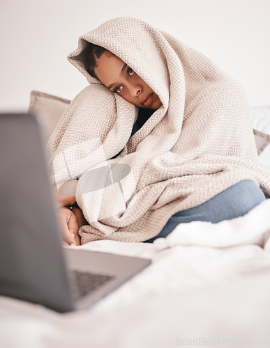 Image of Laptop, mental health problem and insomnia woman from Rome feeling sad on a bed with depression. Depressed person with a computer in a house bedroom blanket with stress, sick or with anxiety at home
