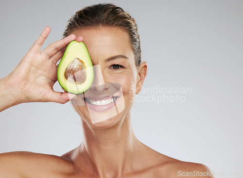 Image of Avocado skincare, woman beauty and natural cosmetics for facial mask, healthy diet and happy results on grey studio background. Portrait of mature model, organic anti aging dermatology and clean face