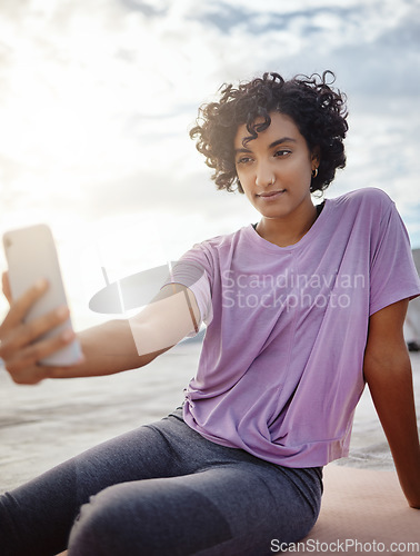 Image of Fitness, exercise and woman taking a selfie on a phone while doing outdoor workout in the city. Healthy, young and girl athlete from puerto rico taking picture on smartphone while doing yoga on a mat