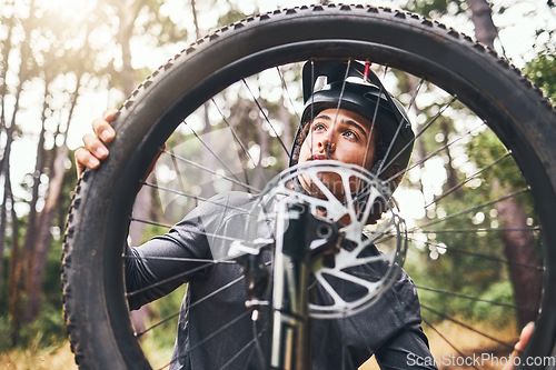 Image of Bicycle, wheel and tyre in forest with man fix problem in zoom or closeup of rim. Cyclist, bike and broken in woods while on training, fitness and travel ride for sport or prepare for competition